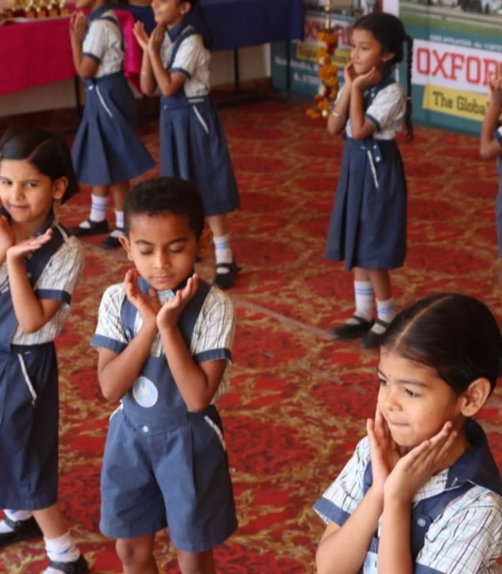 Young students in uniform performing expressive dance moves