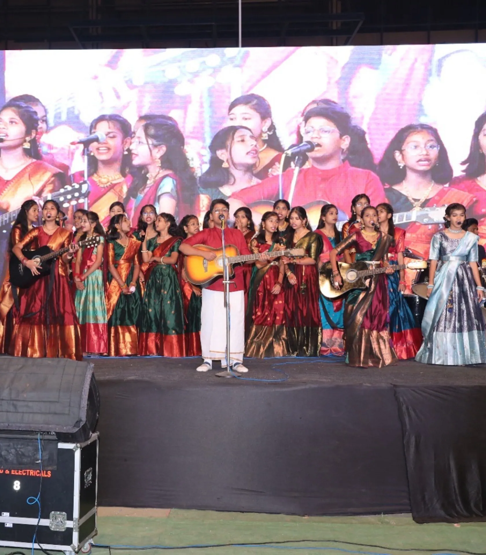 Students singing together on stage at the annual celebration