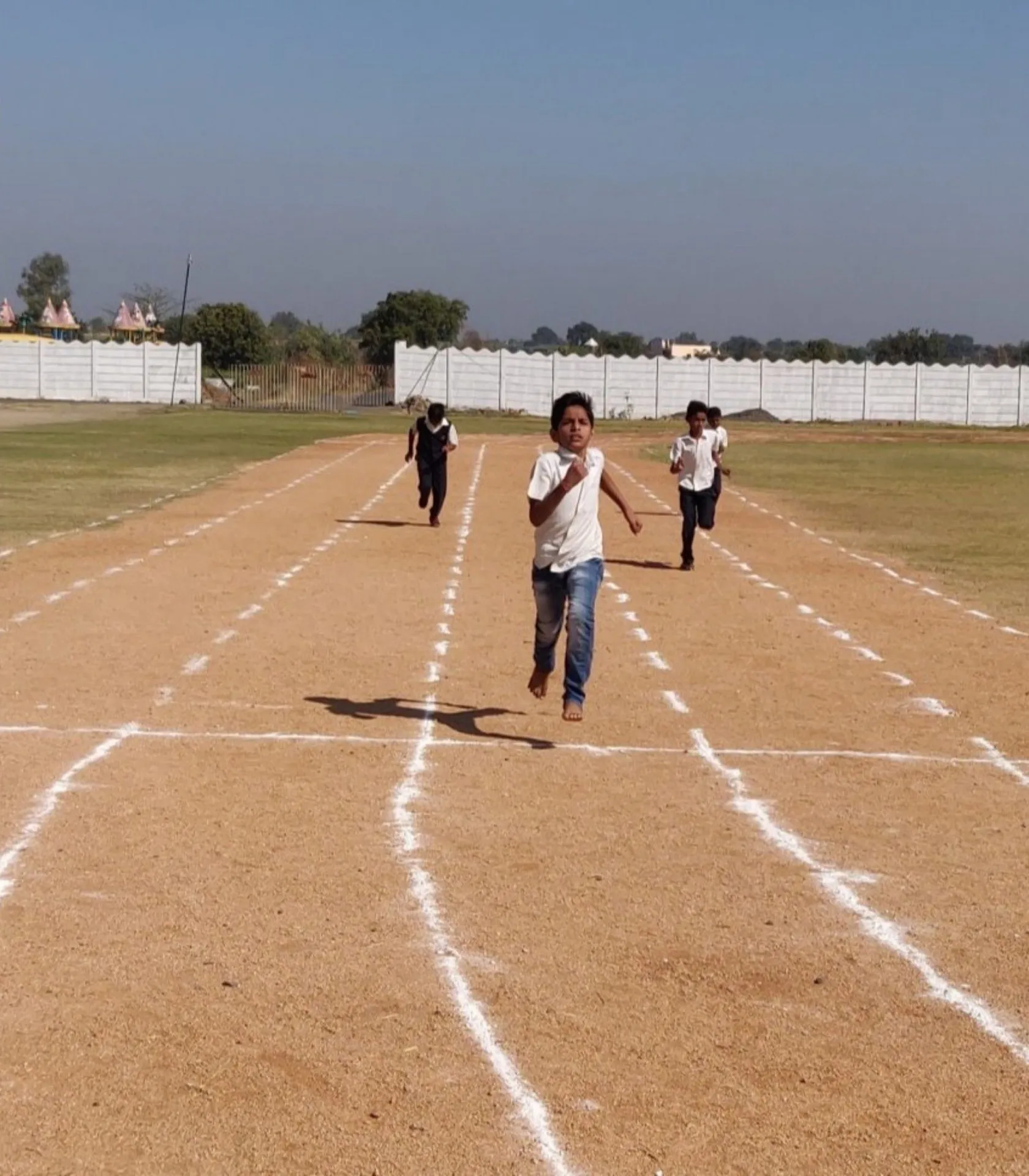 Students racing down the running track on the school sports ground