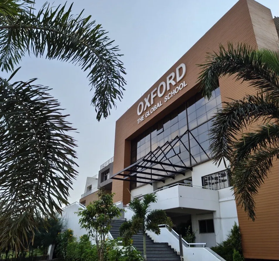 The OXFORD signage on the school building, framed by palm trees