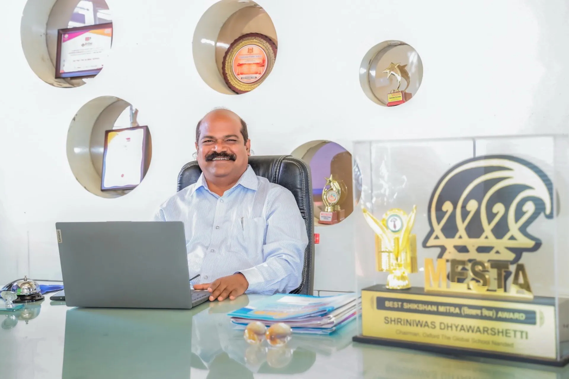 Mr. Srinivas Dhyavarshetty, Chairman, at their desk