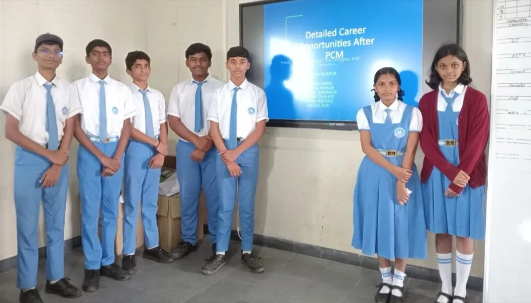 Students presenting their work in front of a smart screen