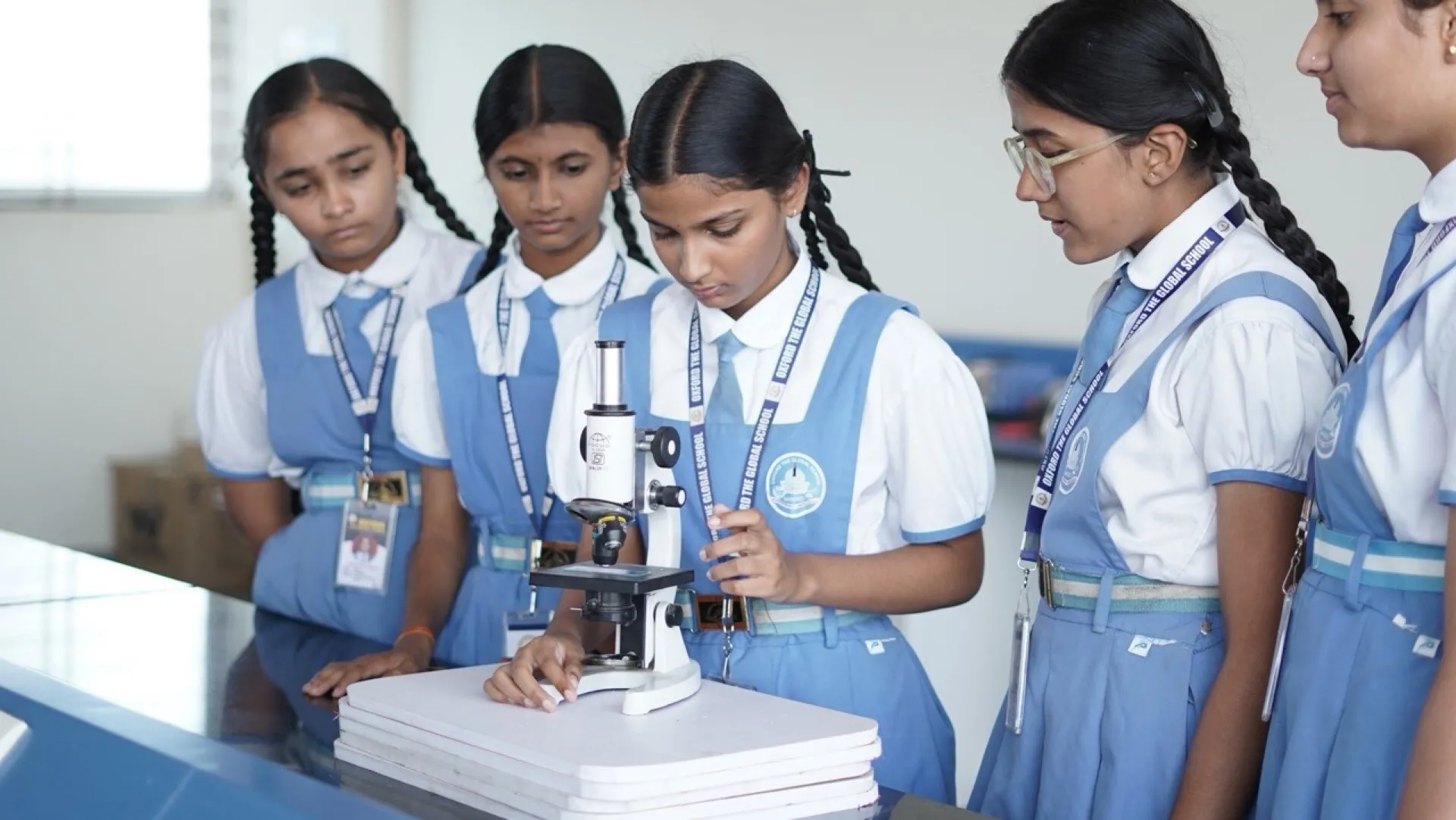 Students observing a slide under a microscope