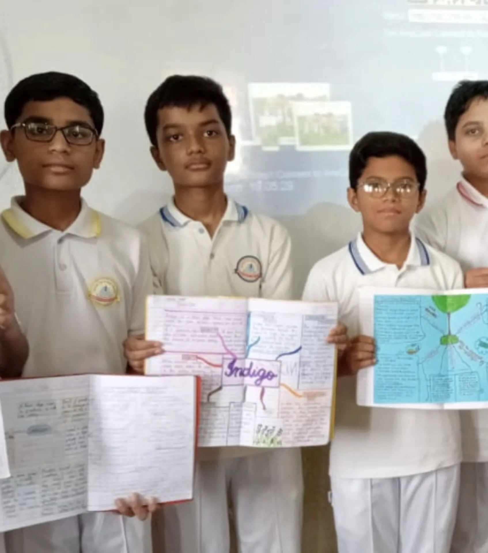 Middle school students in white uniforms presenting their project work