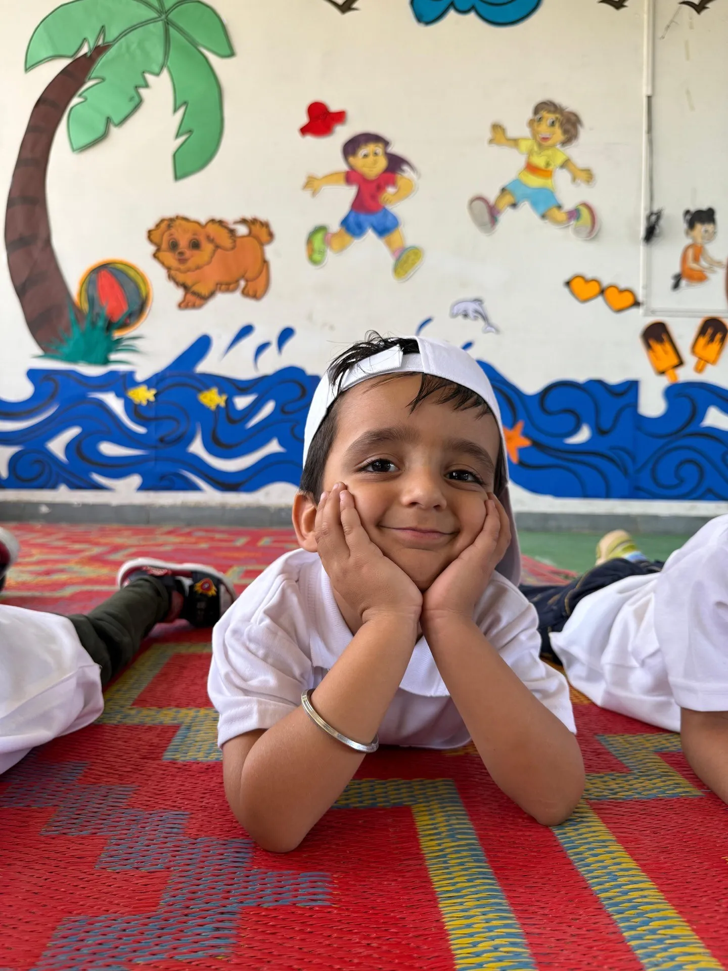 A young camper resting her chin on her hands and smiling